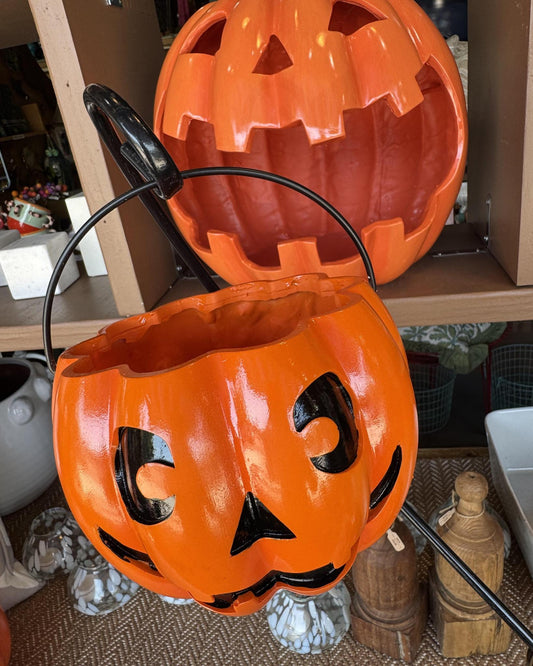 An orange jack-o'-lantern Halloween bucket basket with a black handle. Detail image of a Cat Halloween decoration.