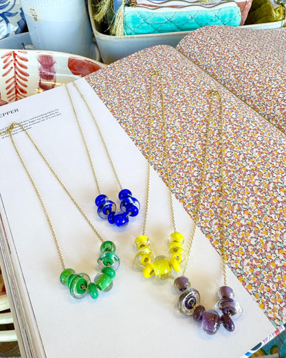Lifesaver Glass Bead Necklaces

The graduated sizes and varied shapes of these playful “Lifesaver” beads create wonderful movement when worn. Some designs feature joyful monochromatic color combinations, while others mix vibrant colors for a more expressive, energetic look. Each necklace has its own personality, from softly coordinated to bright and unexpected.