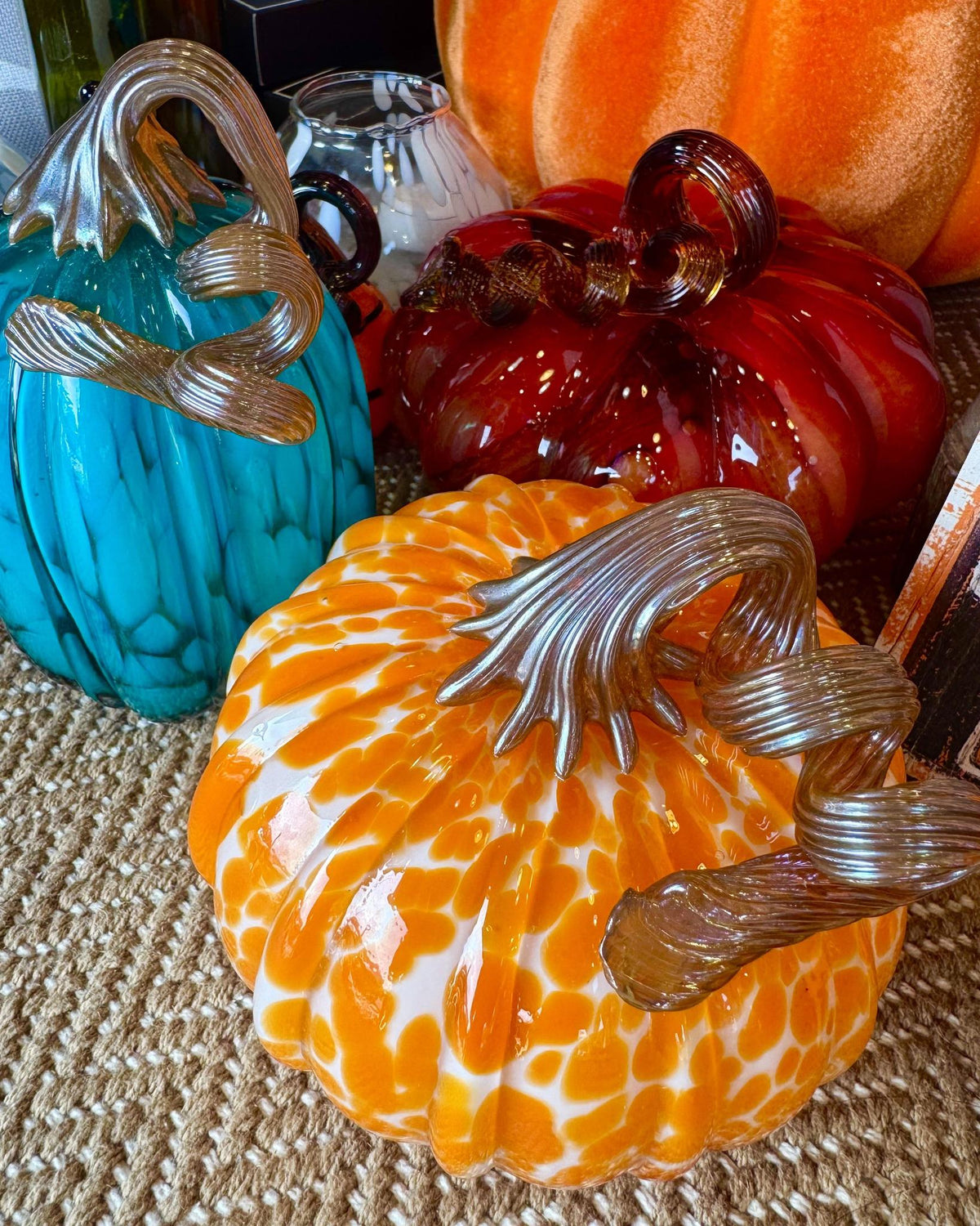 Blown glass pumpkin in light orange and white with silver twisted stem.