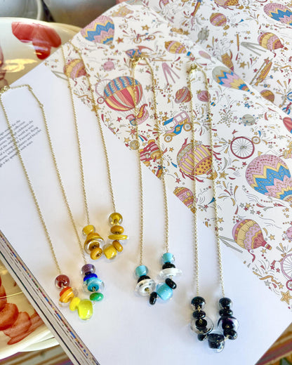 Lifesaver Glass Bead Necklaces

The graduated sizes and varied shapes of these playful “Lifesaver” beads create wonderful movement when worn. Some designs feature joyful monochromatic color combinations, while others mix vibrant colors for a more expressive, energetic look. Each necklace has its own personality, from softly coordinated to bright and unexpected.