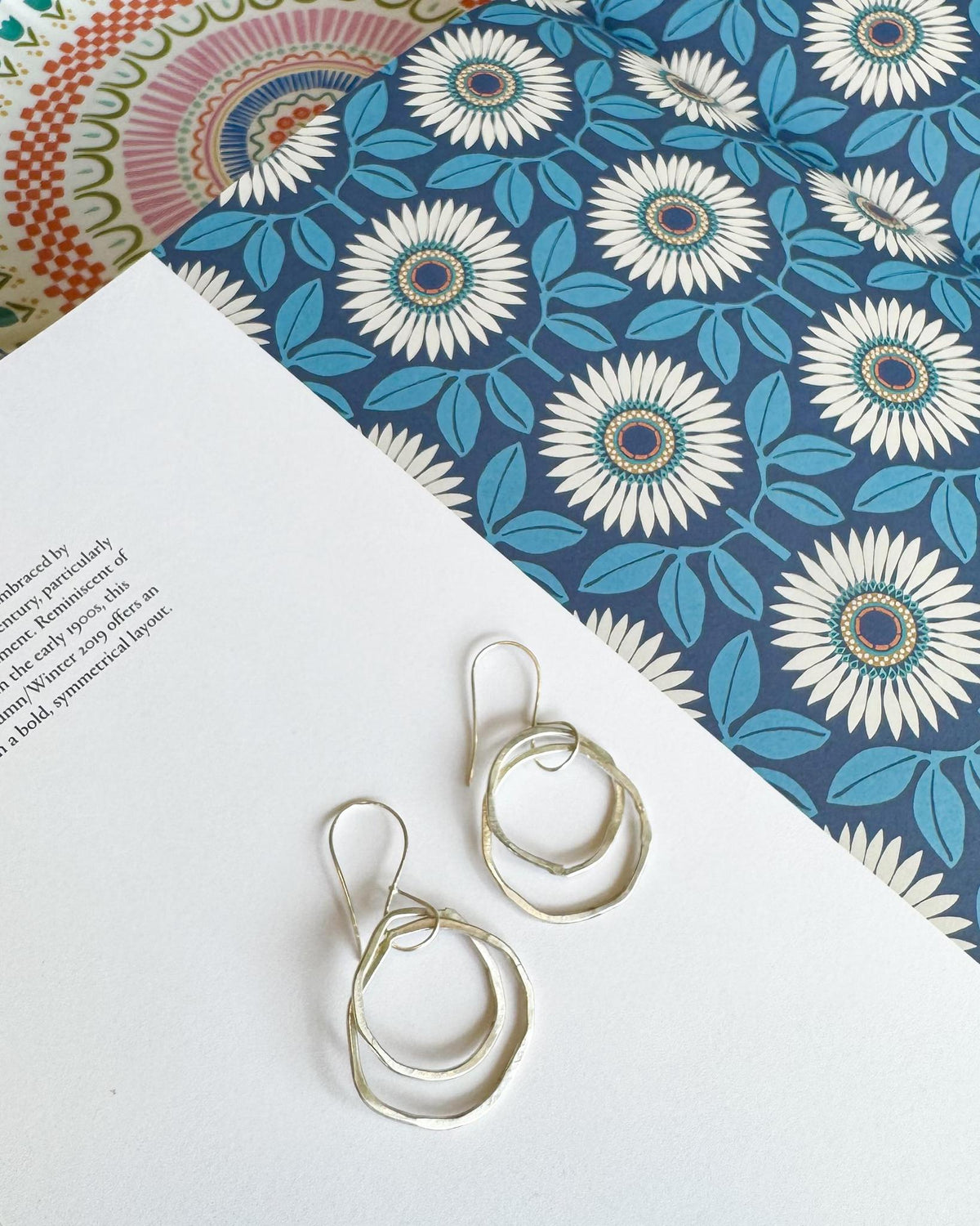 Double Circle Sterling Silver Dangle Earrings

Elegant and sculptural, these sterling silver earrings feature two open circles that dangle in a graceful, slightly offset arrangement. The circles are subtly different in size, creating natural movement and an easy, artful silhouette.